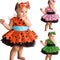 Three children in colorful tutu dresses with headbands on a white background
