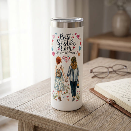 Tumbler with 'Best Sister Ever' design on a wooden table with a notebook and glasses.
