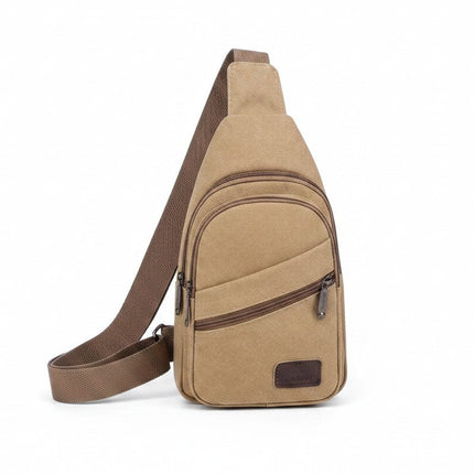 A beige canvas sling bag with a brown adjustable shoulder strap, featuring a front zippered pocket and a small brown brand patch on the lower right, shown against a plain white background.
